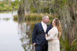 Bridal couple in front of Lake Alice